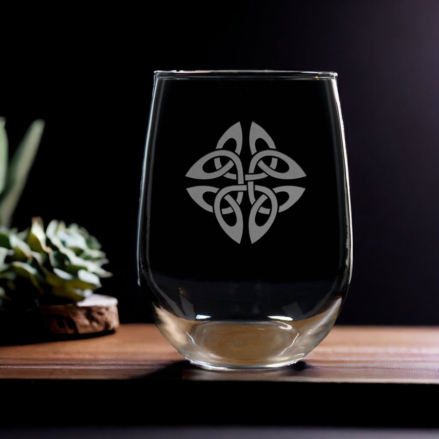 Clear glass with Celtic knot design on a dark background