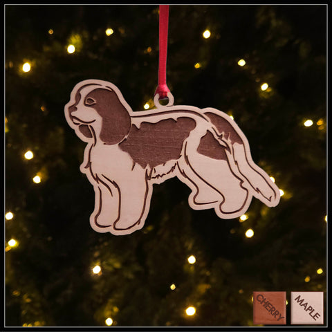 A Cavalier King Charles Spaniel maple wood veneer ornament, with the dog in profile. 