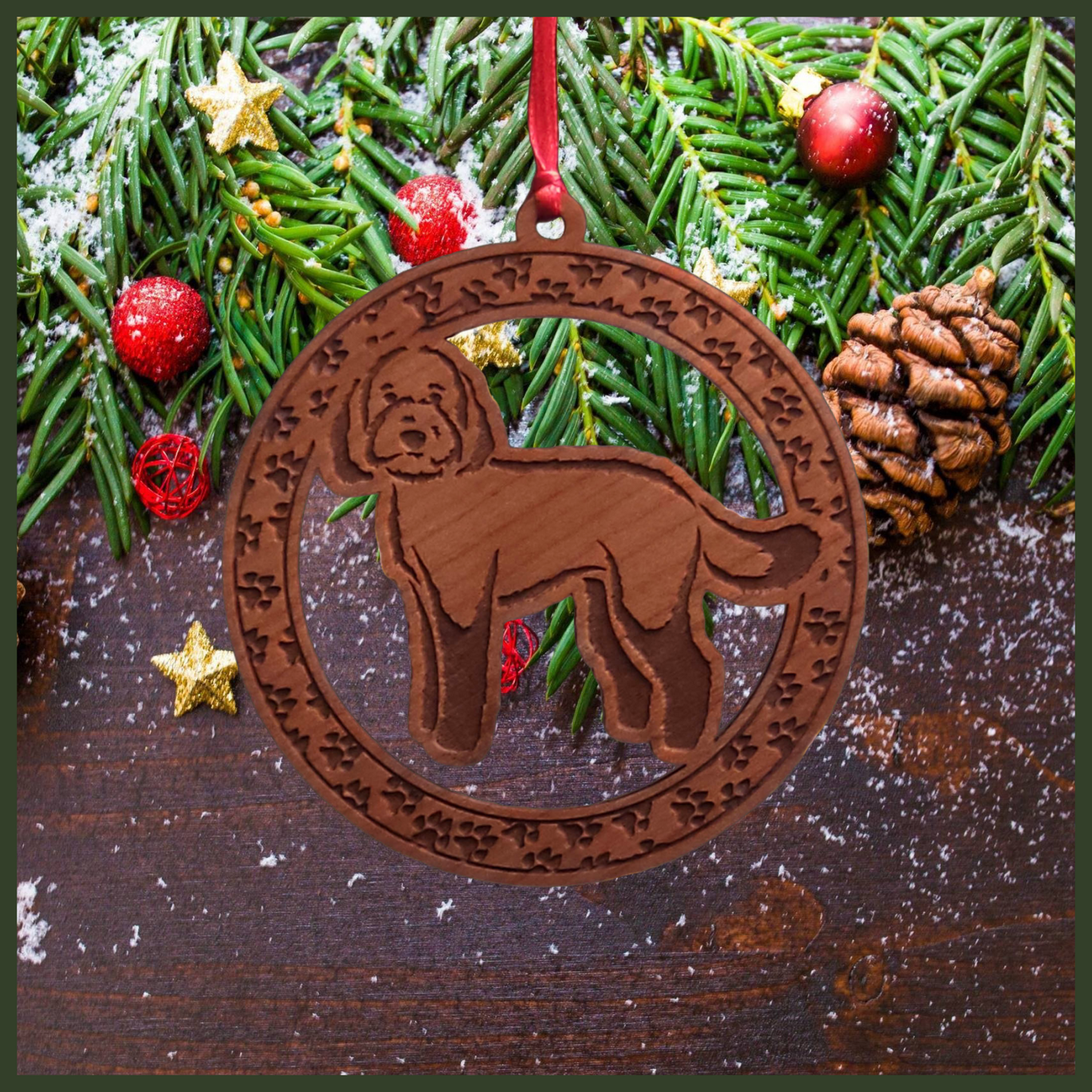 A round cherry wood veneer ornament with a border of small paw prints. The center of the ornament is a labradoodle dog