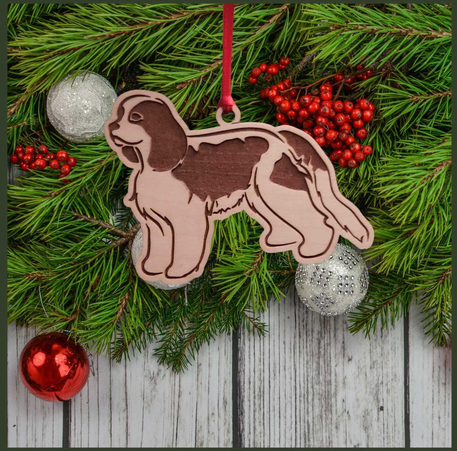 A Cavalier King Charles Spaniel maple wood veneer ornament, with the dog in profile.