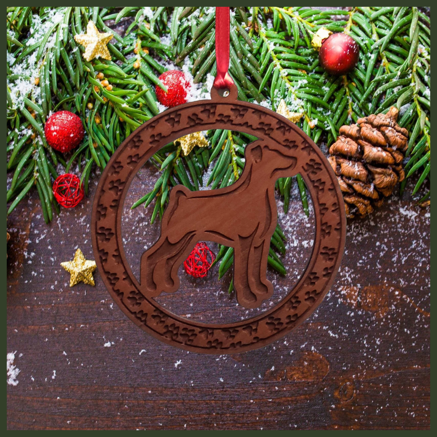 A round maple wood veneer ornament with a border of small paw prints. The center of the ornament is a Doberman dog.