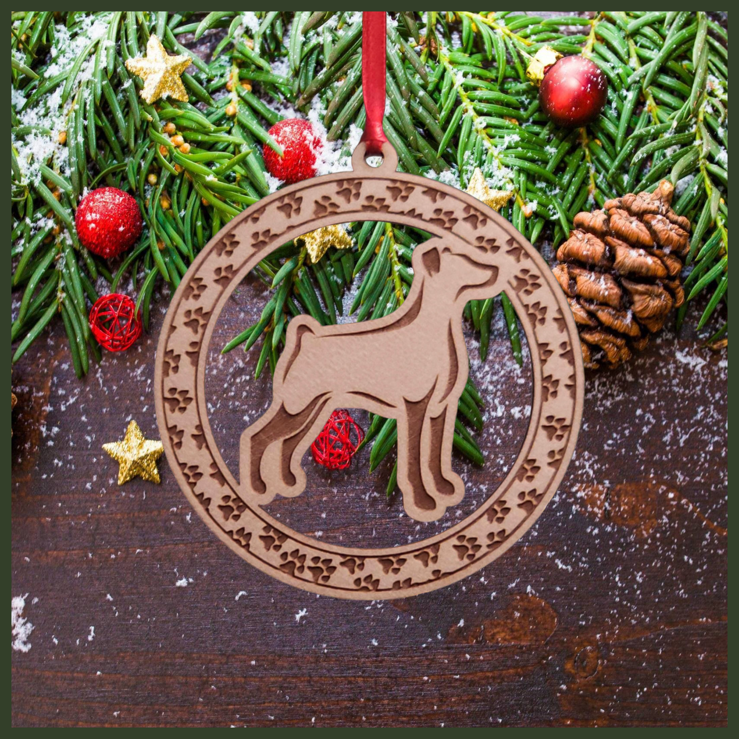 A round maple wood veneer ornament with a border of small paw prints. The center of the ornament is a Doberman dog.