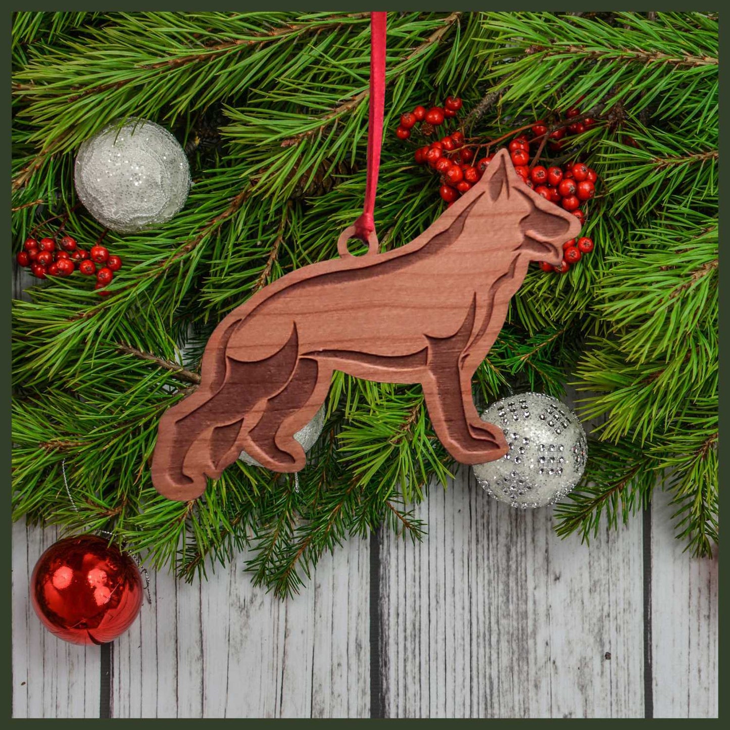 A German Shepherd cherry wood veneer ornament, with the dog in profile.