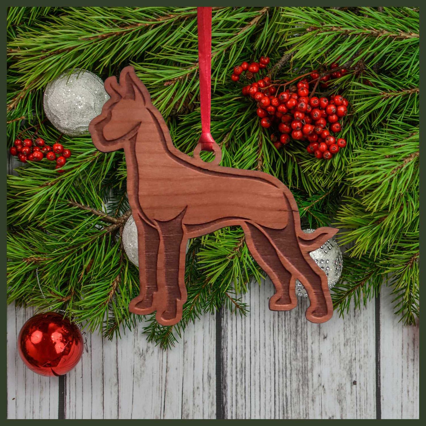 A Great Dane cherry wood veneer ornament, with the dog in profile.