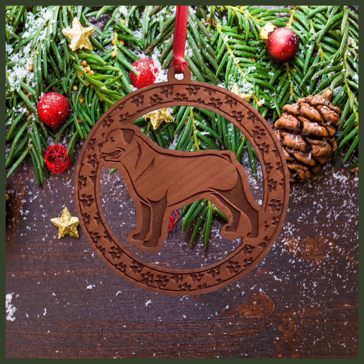 A round cherry wood veneer ornament with a border of small paw prints. The center of the ornament is a Rottweiler dog.