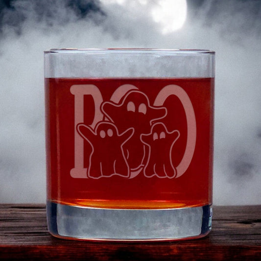 An image of an 11oz whiskey glass with a misty background with three ghosts standing in front of a large word "BOO"