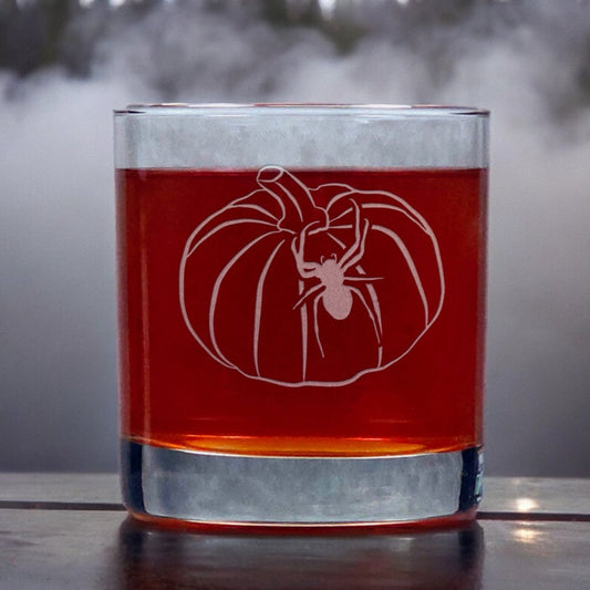 An image of an 11oz whiskey glass an image of a pumpkin with a spider crawling up the side