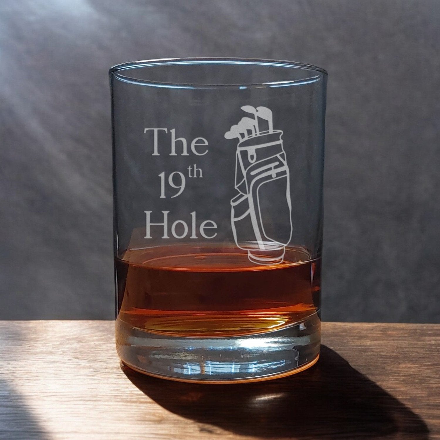 A 13 oz Whisky Glass with an etched golf bag and the words "The 19th Hole" referring to the pub or restaurant at the end of the game - Copyright Hues in Glass