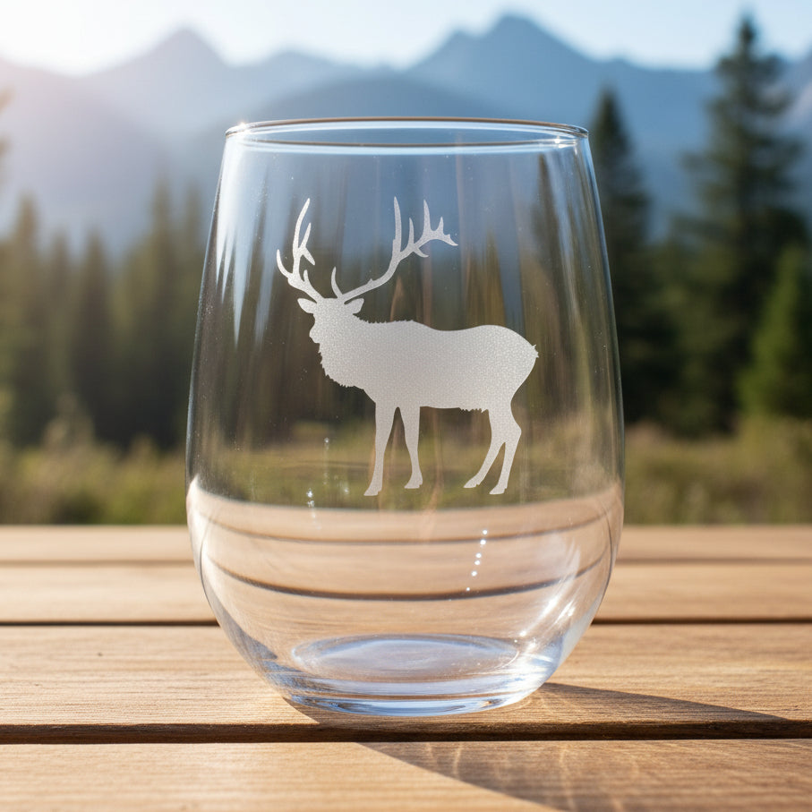 17oz Stemless Wine Glass with an etched image of an etched elk design with a background of a misty forest