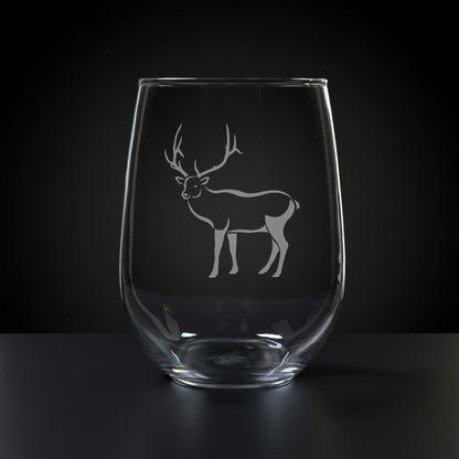 17oz Stemless Wine Glass with an etched image of a bear paw print, on a wood surface and a black background