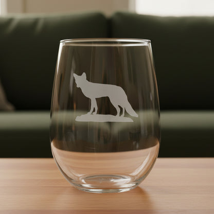 17oz Stemless Wine Glass with an etched image of a fox  and a green couch in the background