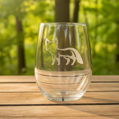 17oz Stemless Wine Glass with an etched image of an fox with a background of a trees 