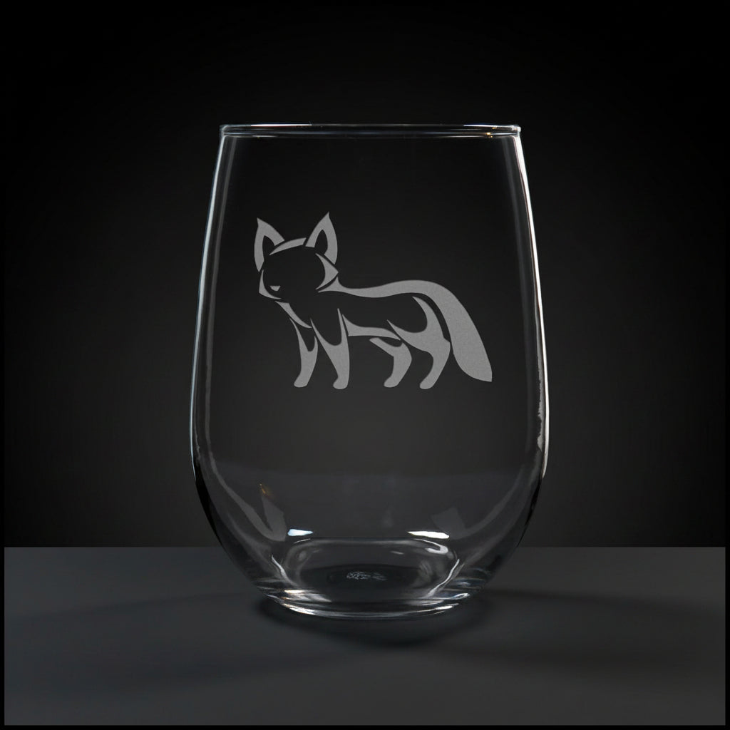 17oz Stemless Wine Glass with an etched image of a fox, on a wood surface and a black background