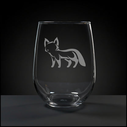 17oz Stemless Wine Glass with an etched image of a fox, on a wood surface and a black background
