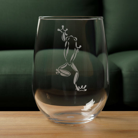 17oz Stemless Wine Glass with an etched image of a garden frog 
and a green couch in the background