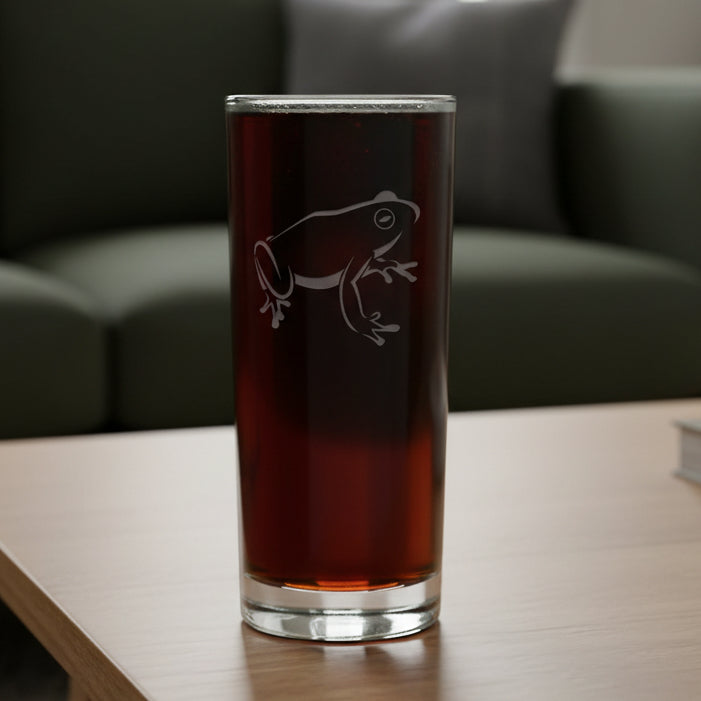 15oz Cooler Glass with an etched image of a sitting frog and a green couch in the background