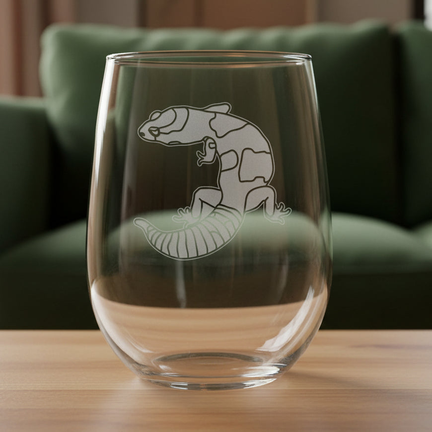 17oz Stemless Wine Glass with an etched image of a gecko
and a green couch in the background