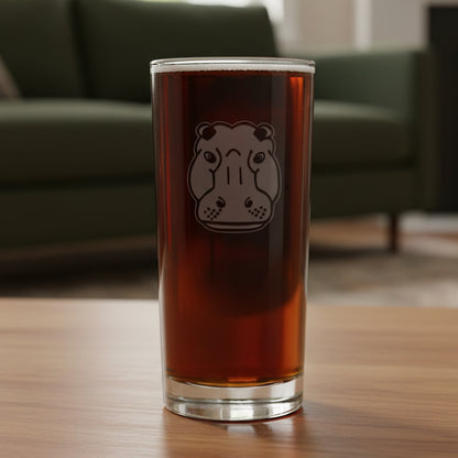 15oz Cooler Glass with an etched image of a hippo head and a green couch in the background