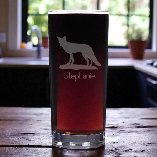 Glass with wolf design and 'Stephanie' text on a wooden table