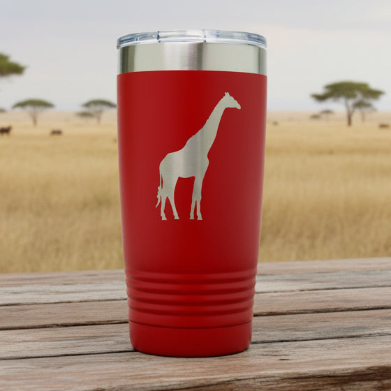 Red tumbler with a white giraffe design on a white background