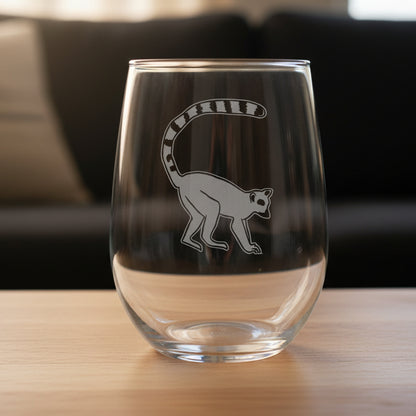 Clear glass with a lemur design on a wooden surface and black background