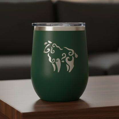 Green wine tumbler with a sheep on a wooden surface
