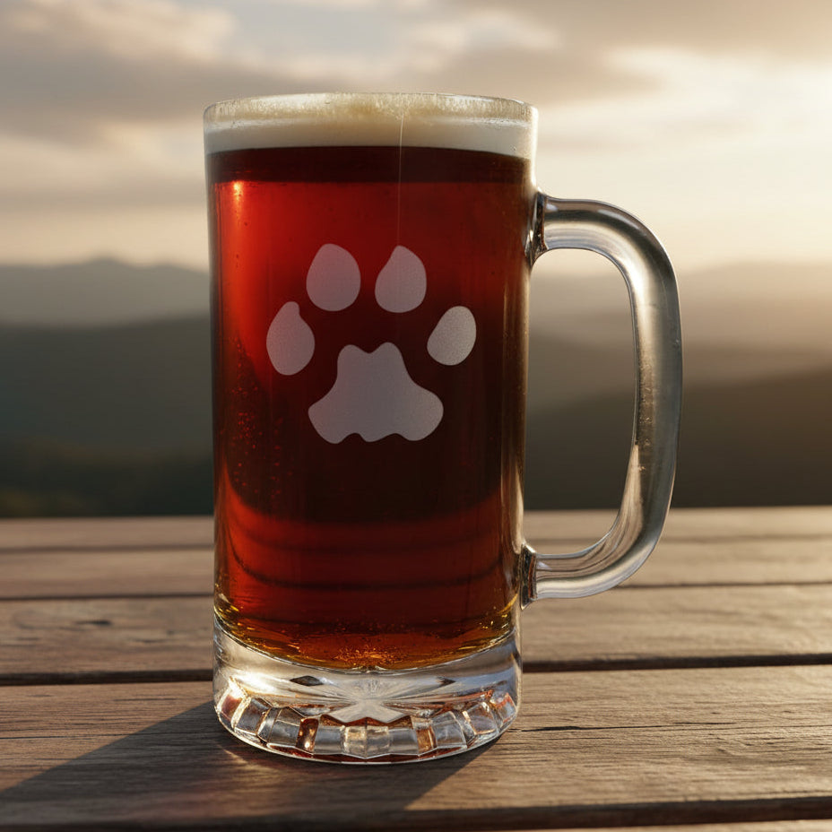 16oz Beer Mug with an etched image of a bear paw print with a background of  misty mountains