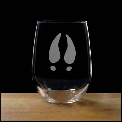 17oz Stemless Wine Glass with an etched image of a Deer Track, on a wood surface with a black background