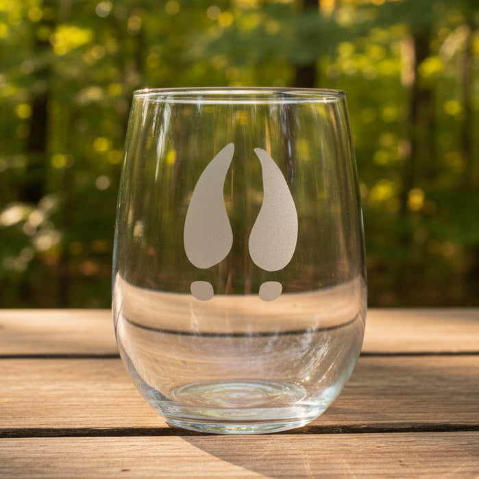17oz Stemless Wine Glass with an etched image of a deer track  with a forest in the background