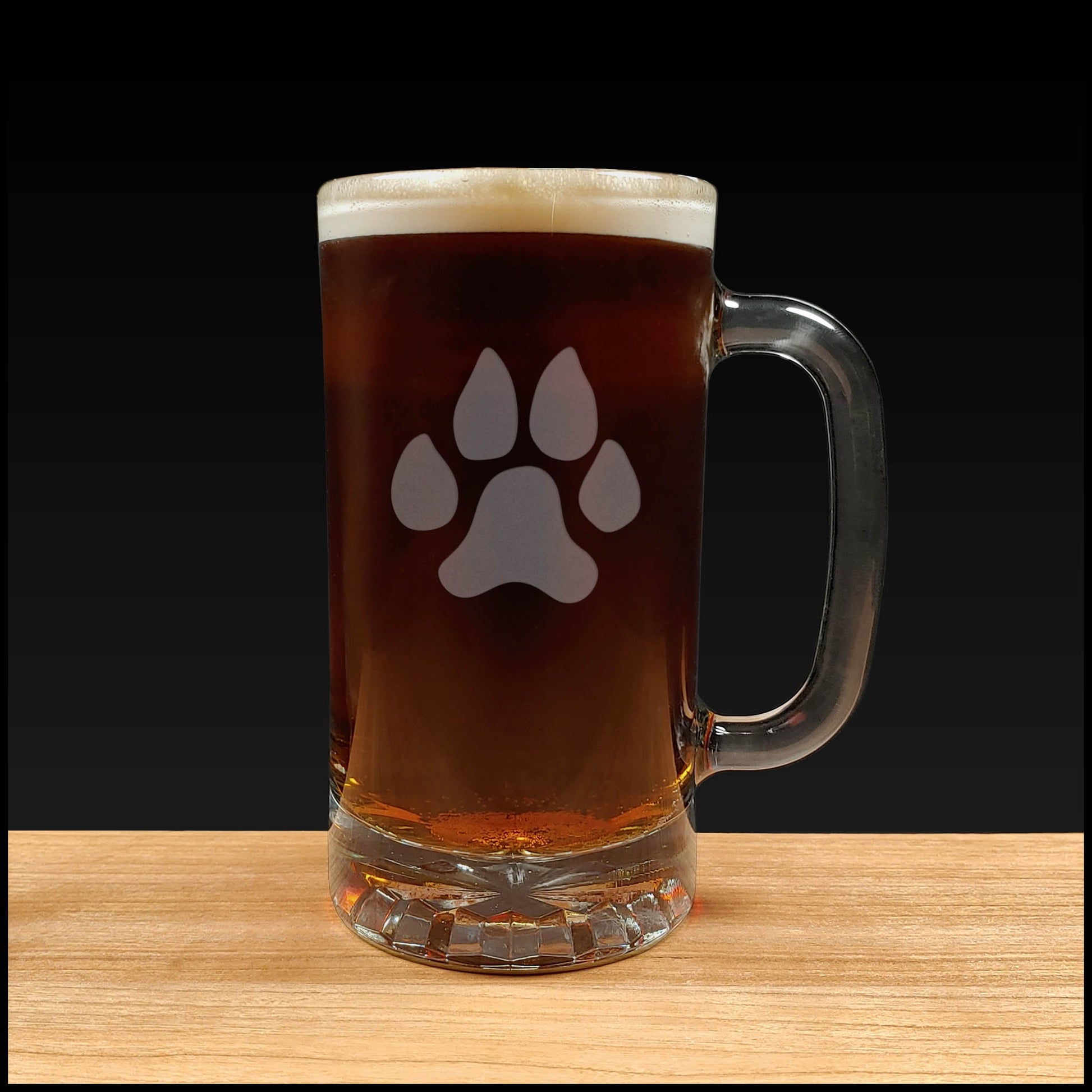 16oz Beer Mug with an etched image of a dog paw print a grey  background