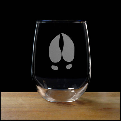17oz Stemless Wine Glass with an etched image of a moose track, on a wood surface and a black background