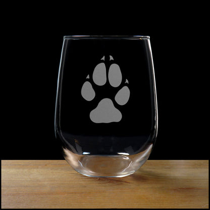 Wolf track stemless wine glass on a wood surface with a black background