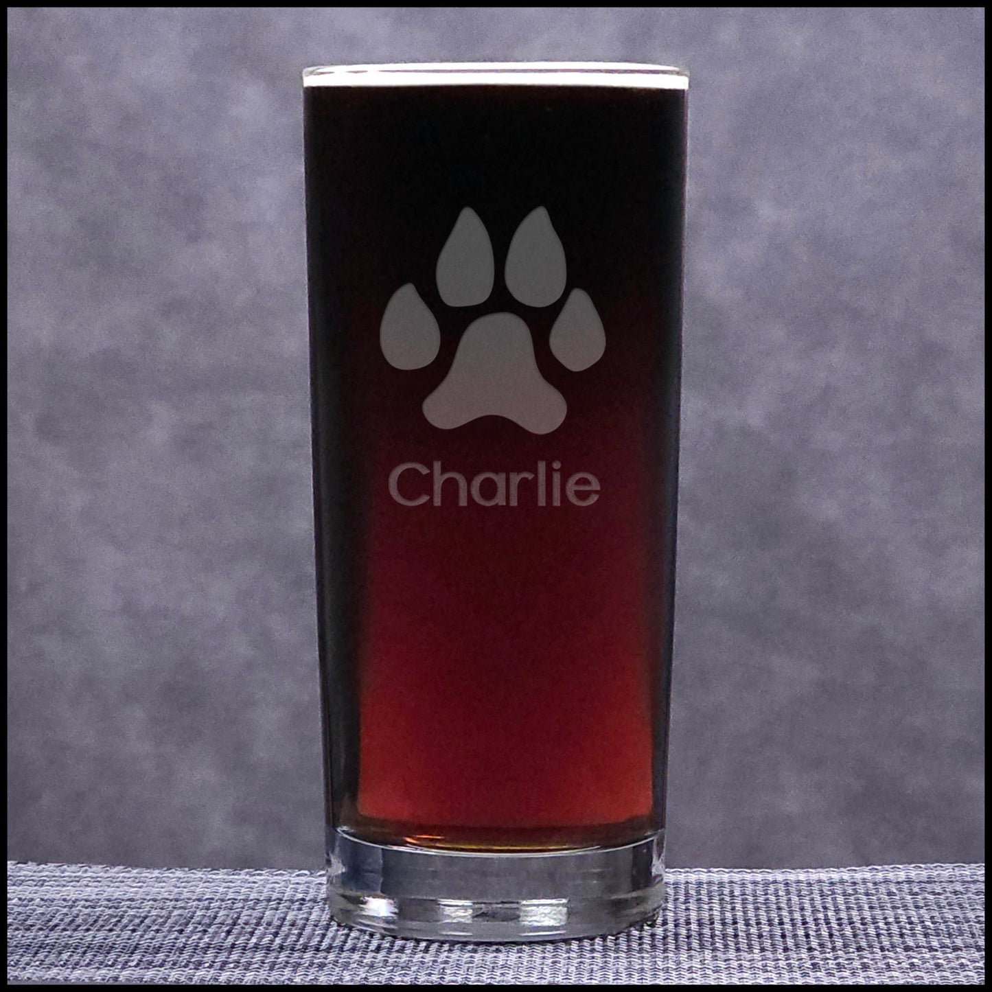A 15.75oz Cooler Glass with an etched Dog Paw and Personalization - Copyright Hues in Glass