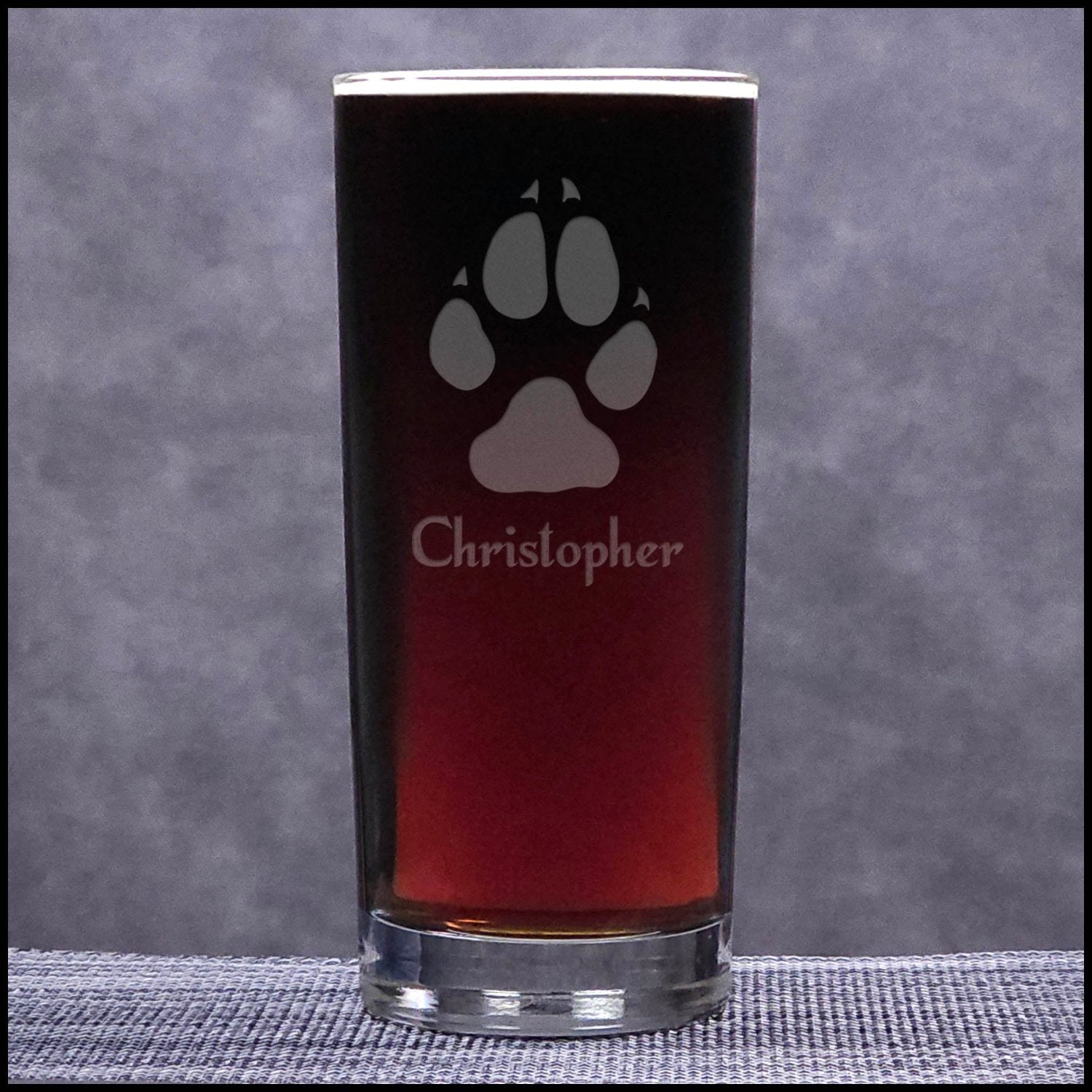 A 15.75oz Cooler Glass with an etched Wolf Track and Personalization - Copyright Hues in Glass