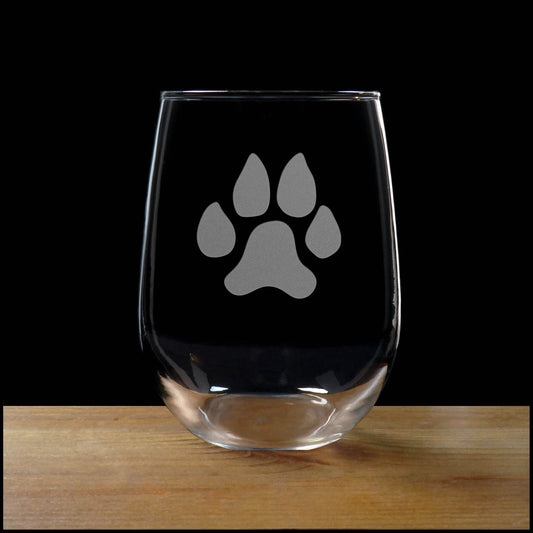 Clear glass with a paw print design on a wooden surface and black background