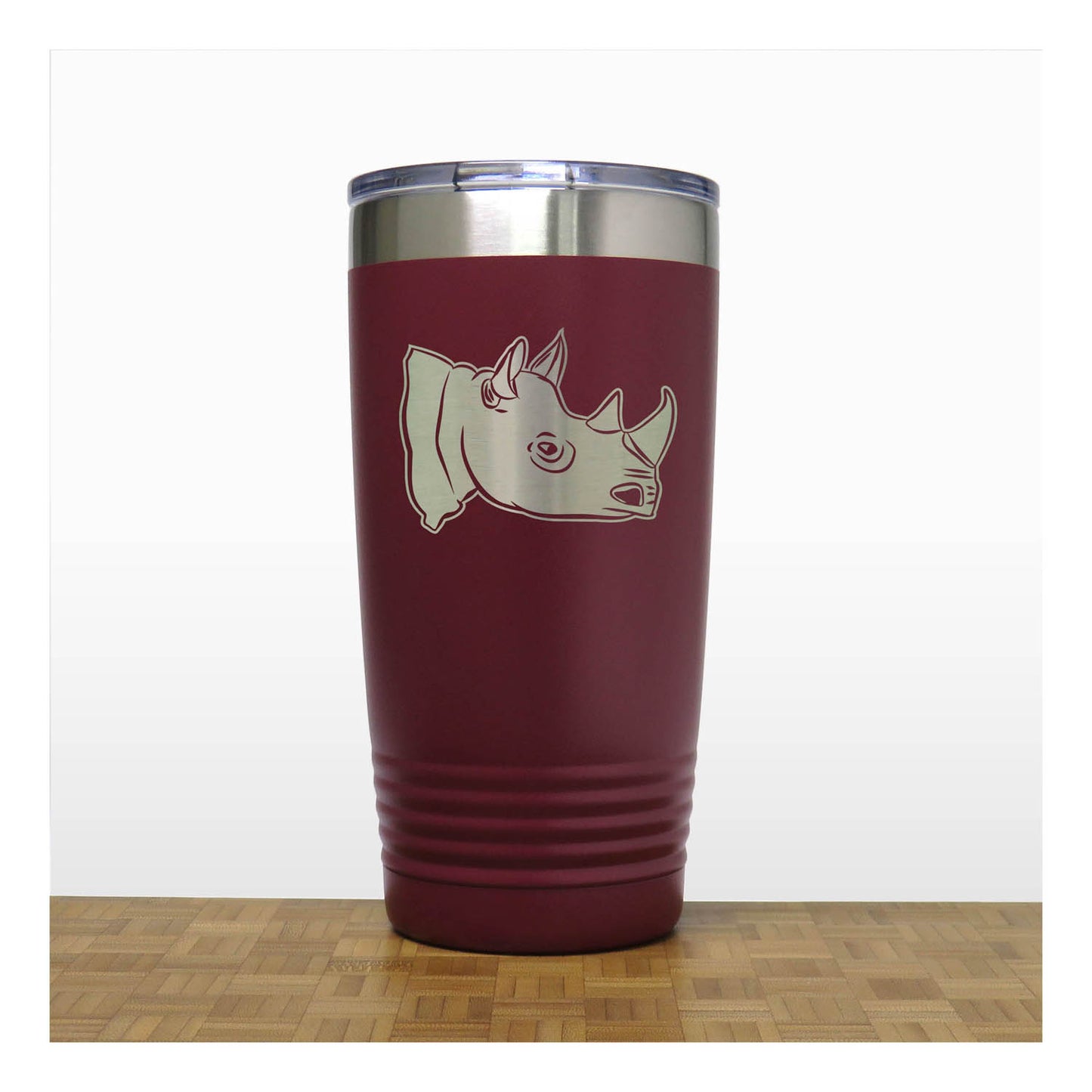 Maroon tumbler with rhino design on a white background