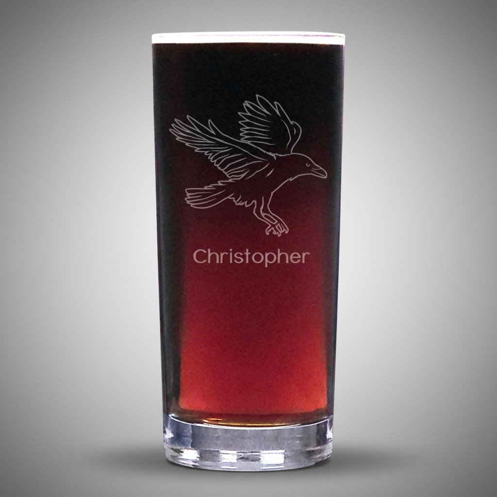Glass with engraved bird design and 'Christopher' text on a white background