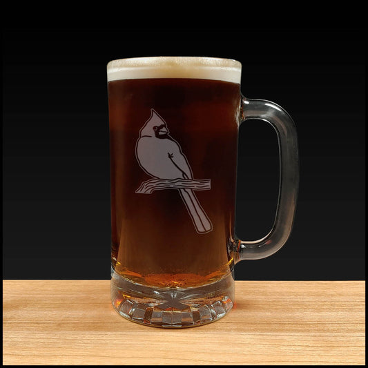 Glass mug with a Cardinal bird design filled with beer on a wooden surface