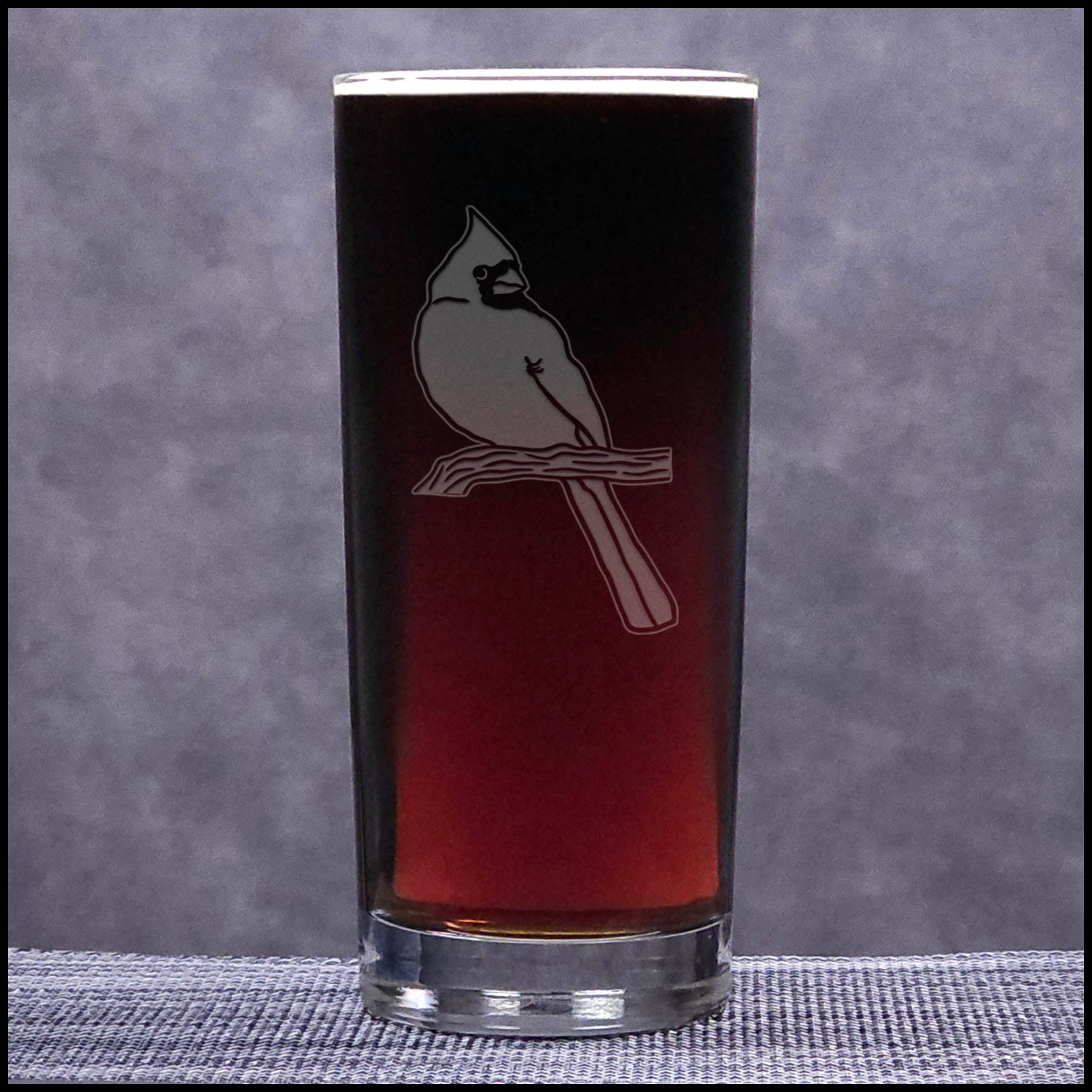 Glass with bird design on a gray background