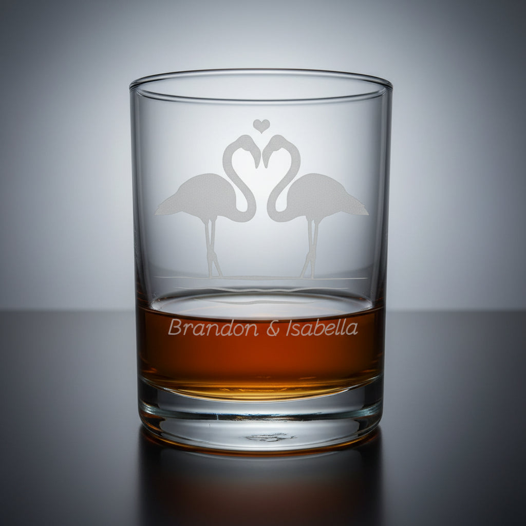 Glass tumbler with engraved flamingo design and 'Brandon & Isabella' text 