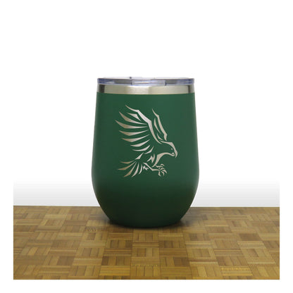 Green insulated tumbler with an eagle design on a wooden surface