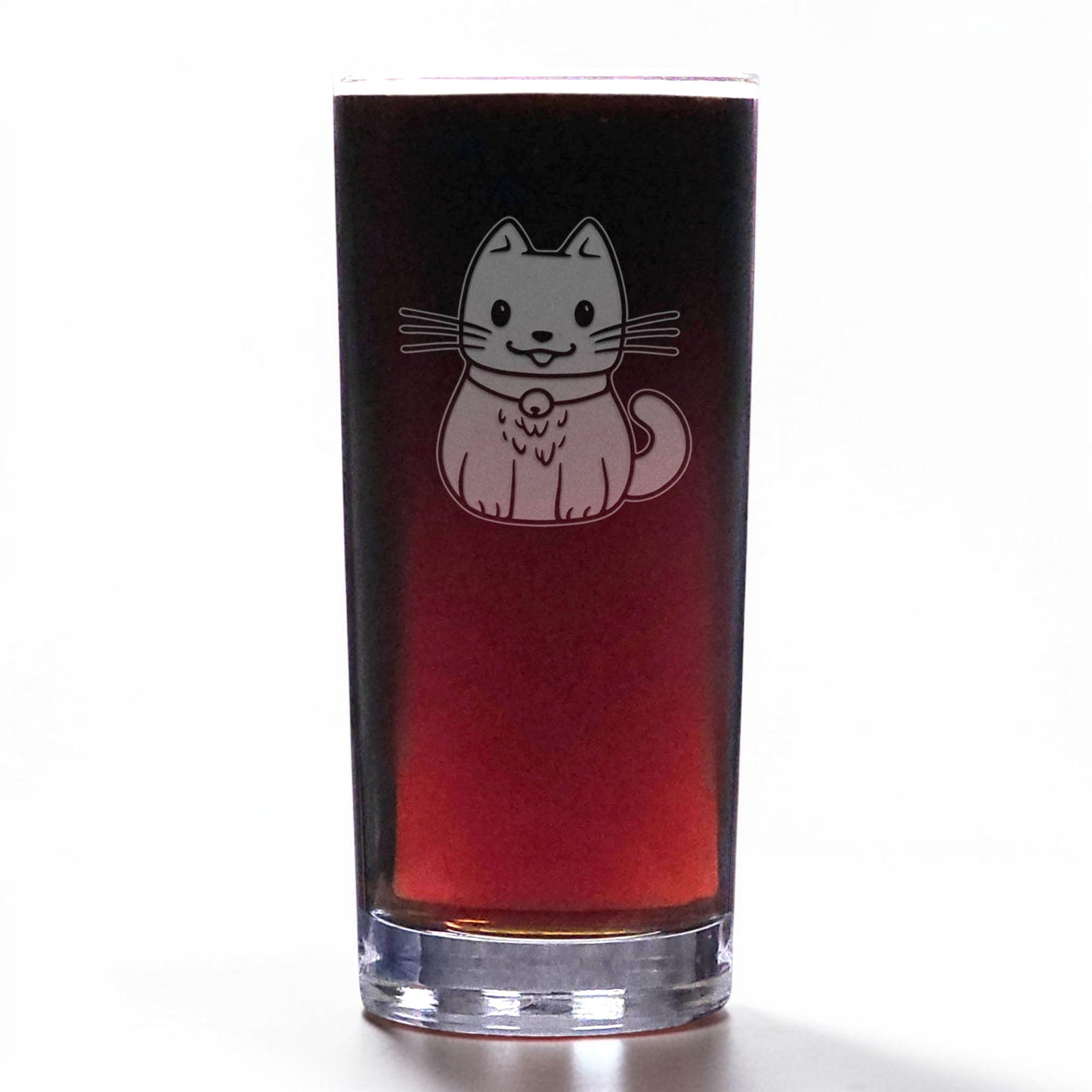 A clear glass shot glass filled with a dark red liquid, featuring an etched cute cat wearing a collar on the front, set against a plain white background.