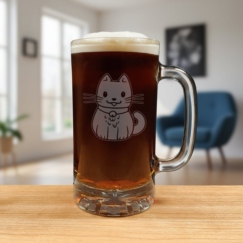 A clear glass beer mug filled with dark beer and topped with white foam, featuring an etched cute cat design on the front, set on a wooden surface against a living room background.