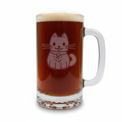 A clear glass beer mug filled with dark beer and topped with white foam, featuring an etched cat design on the front, set on a wooden surface against a white background.