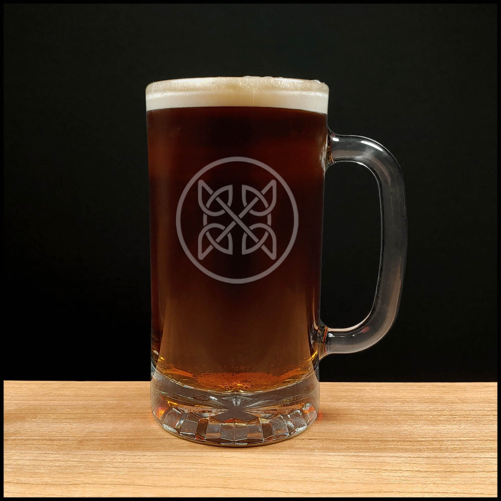 Glass mug of dark beer with a logo on a wooden surface and black background