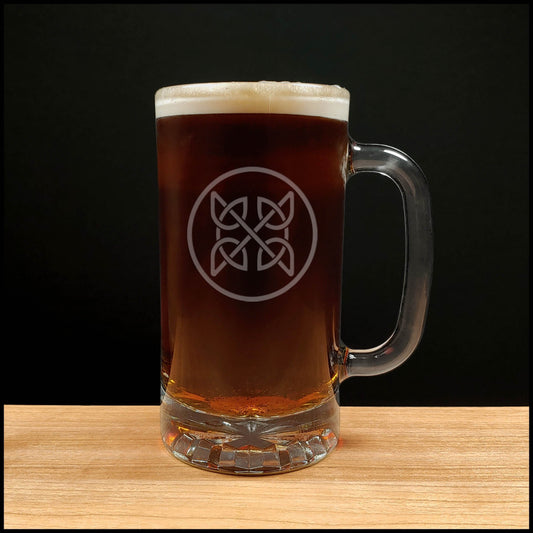 Glass mug of dark beer with a logo on a wooden surface and black background