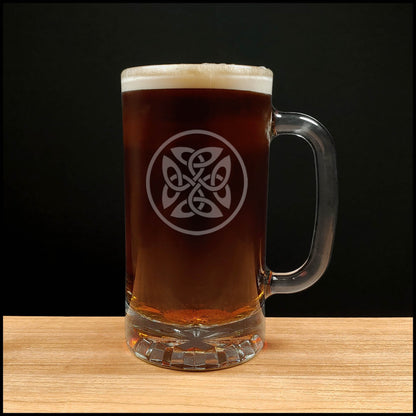 Glass mug of dark beer with a Celtic knot design on a wooden surface and black background