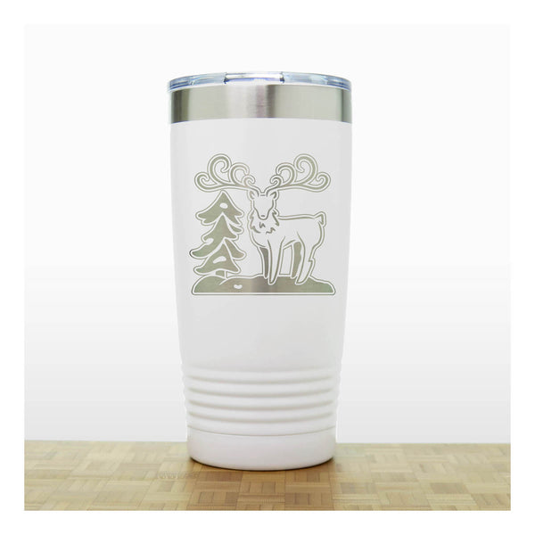 White - Insulated Travel Mug with the design of a Reindeer sta nding beside a Christmas tree - Copyright Hues in Glass
