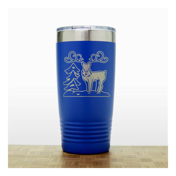 Blue - Insulated Travel Mug with the design of a Reindeer sta nding beside a Christmas tree - Copyright Hues in Glass