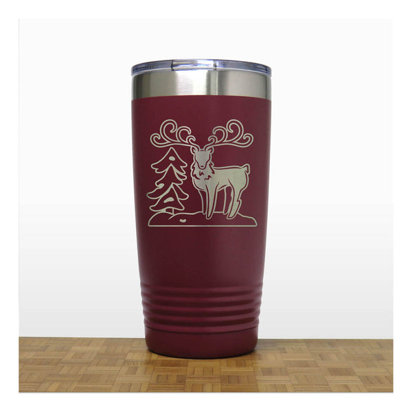 Maroon - Insulated Travel Mug with the design of a Reindeer sta nding beside a Christmas tree - Copyright Hues in Glass